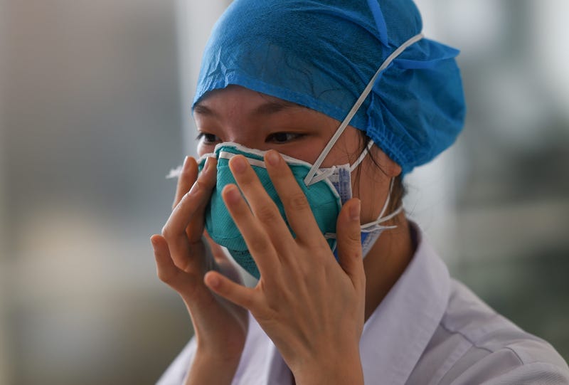 A medical worker learns how to wear masks during a medical training session at People's Hospital of Chengmai County, south China's Hainan province, Feb. 11, 2020.