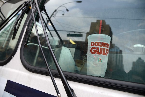 A large 64 ounce "Double Big Gulp" cup sits on the dash of an MTA crosstown bus in New York, NY, on March 11, 2013
