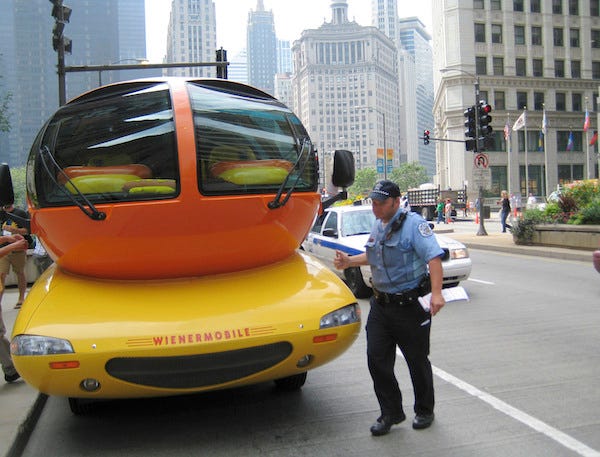A Chicago police officer tickets the Oscar Mayer Wienermobile in the 400 block of North Michigan Avenue, August 9, 2007, in Chicago.