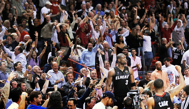 Miami Heat's Dwyane Wade jumps on the tables at mid-court after hitting his buzzer beater in double overtime to beat Chicago 130-127 at the AmericanAirlines Arena in Miami, Florida, Monday, March 9, 2009. (Photo by Robert Duyos/Sun Sentinel/MCT/Sipa USA)
