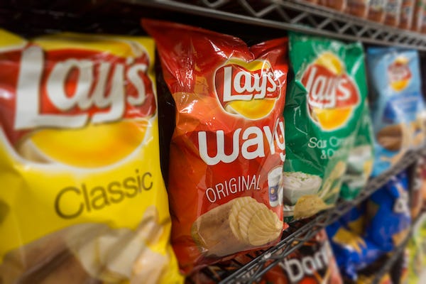 Bags of Lay's potato chips on a store shelf