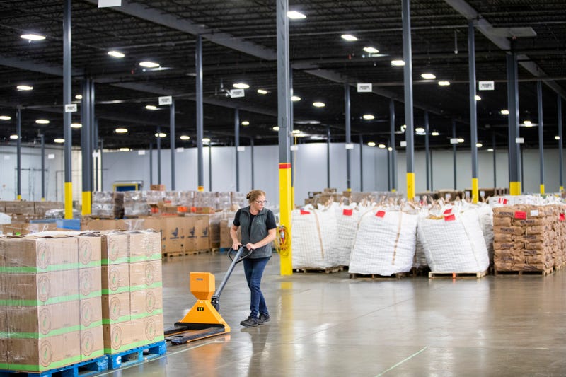 A volunteer with Second Harvest Heartland moves pallets of boxed food at their warehouse location. A federal program that provides food assistance to 40 million low-income people could be at risk in November if the government shutdown isn't resolved by then.