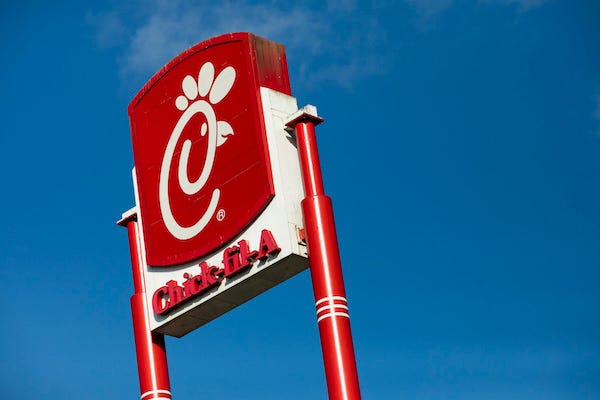A logo sign outside of a Chick-fil-A restaurant location in Martinsburg, West Virginia
