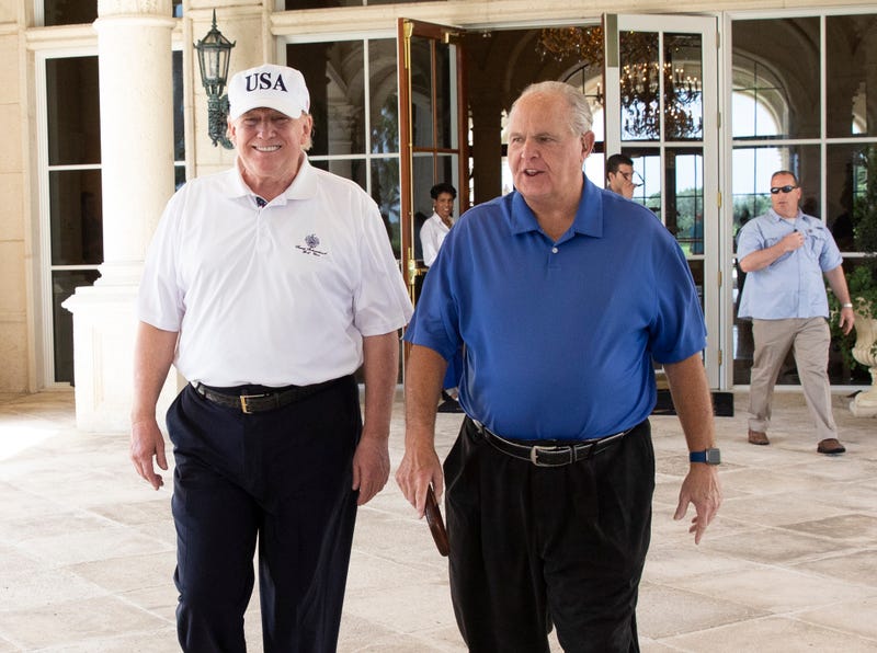 File: President Donald J. Trump and radio commentator Rush Limbaugh walk together Friday, April 19, 2019, following their round of golf at the Trump International Golf Club in West Palm Beach, Fla