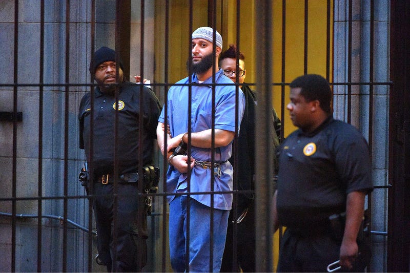 Officials escort "Serial" podcast subject Adnan Syed from the courthouse on Feb. 3, 2016, following the completion of the first day of hearings for a retrial in Baltimore, Md.