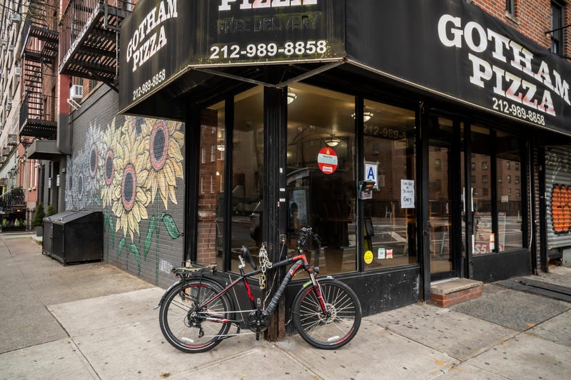 A delivery bike locked up outside a pizzeria in the Chelsea New York neighborhood on Tuesday, March 31, 2020.