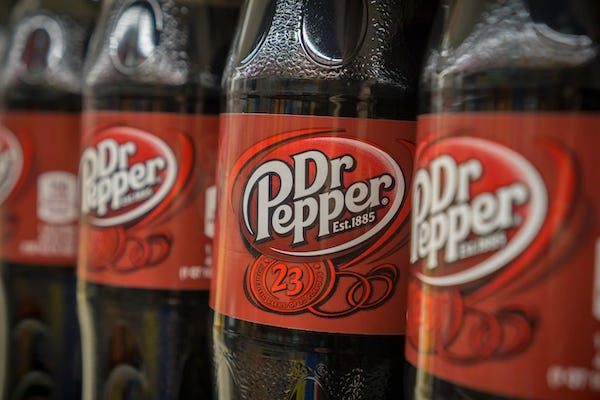 Bottles of Dr. Pepper soda on a supermarket shelf