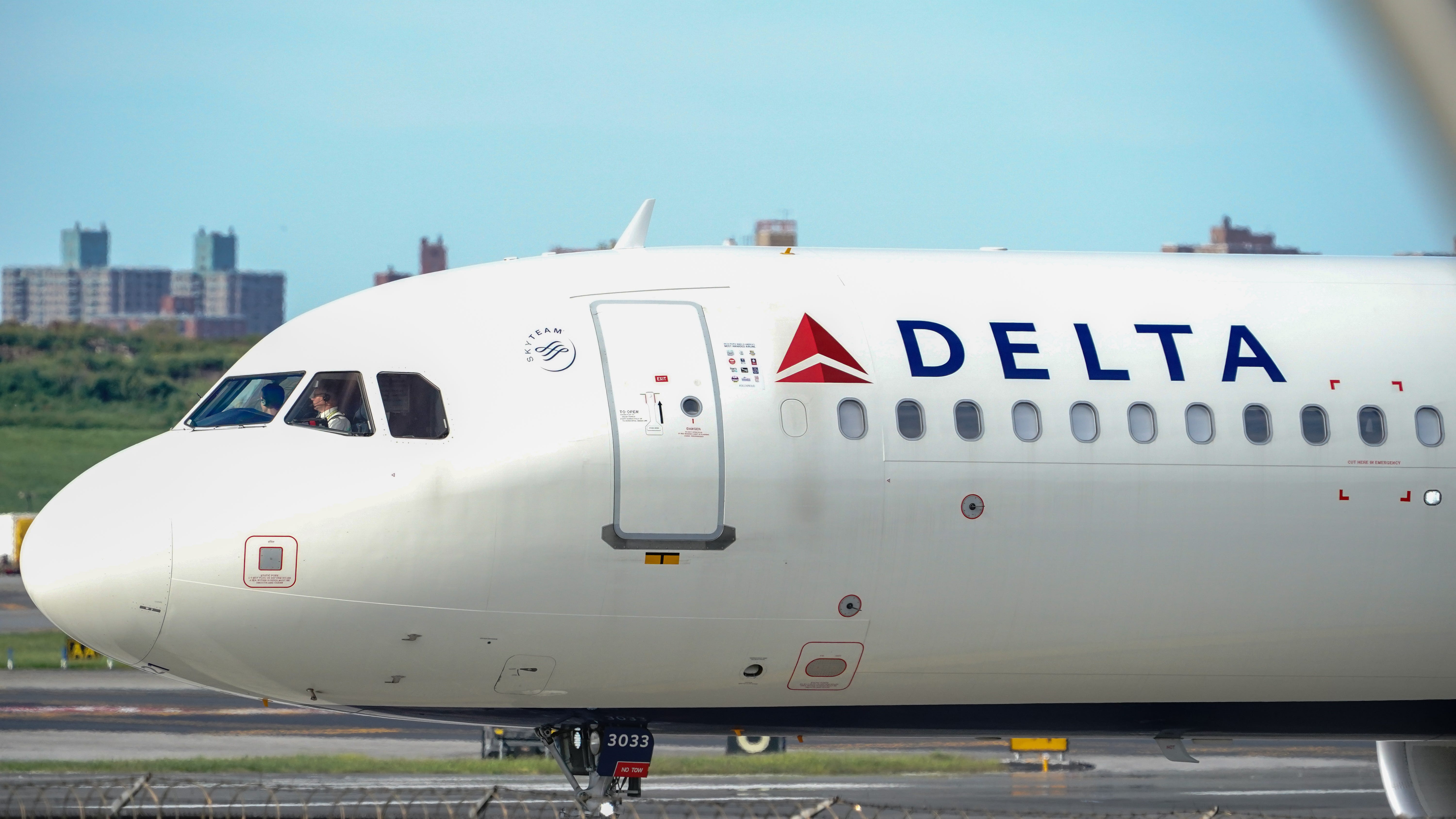 Couple, service dog exit moving Delta flight via emergency slide at NYC airport