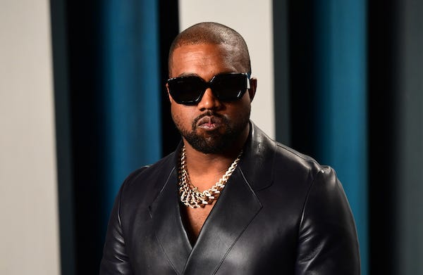 Kanye West posing on a red carpet