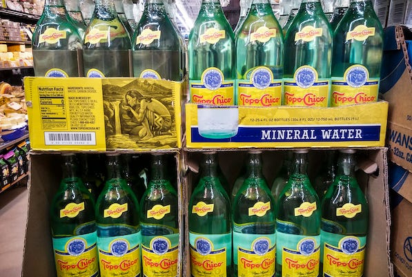 Bottles of Topo Chico in a grocery store