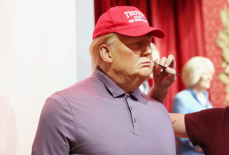 Wax figure of Donald Trump getting touched up