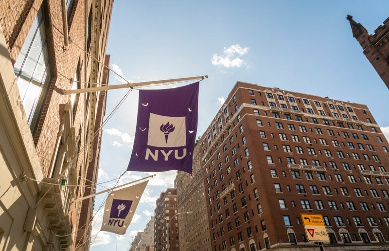 Flags fly outside of a New York University dorm on Fifth Avenue in Greenwich Village in New York on Sunday, March 14, 2021.