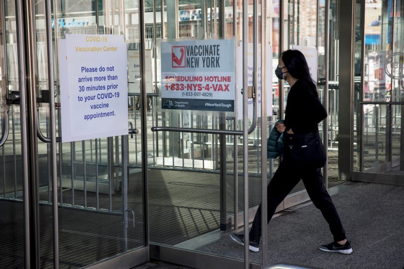 A woman enters a COVID-19 vaccination site at the Javits Center in New York