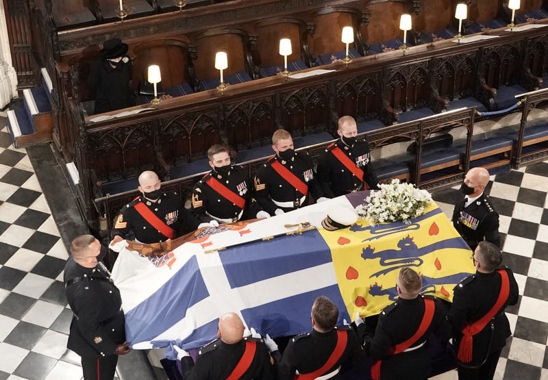 Queen Elizabeth II watches as the coffin of the Duke of Edinburgh is placed St George's Chapel, Windsor Castle, Berkshire during his funeral service. 