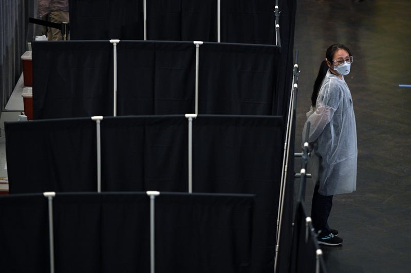 A medical worker stands next to a screened of area for people receiving vaccination shots at the newly opened COVID-19 vaccination site inside the American Museum of Natural History, New York, NY, April 23, 2021