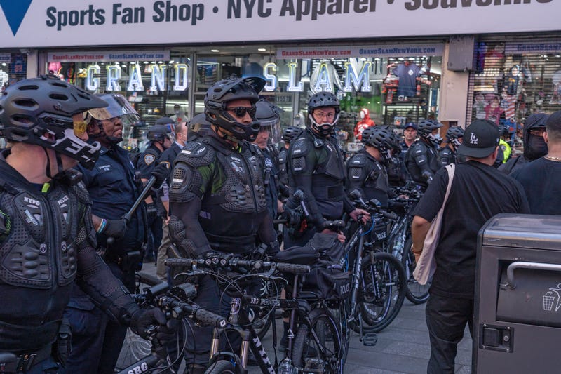 NYPD officers drive away protesters in a violent clash in Times Square on Thursday