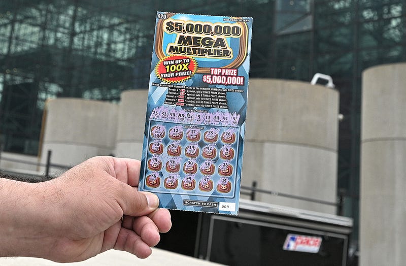 File photo: A man shows his free lottery ticket (normally $20 to buy) after getting his first COVID-19 vaccine shot on May 24, 2021