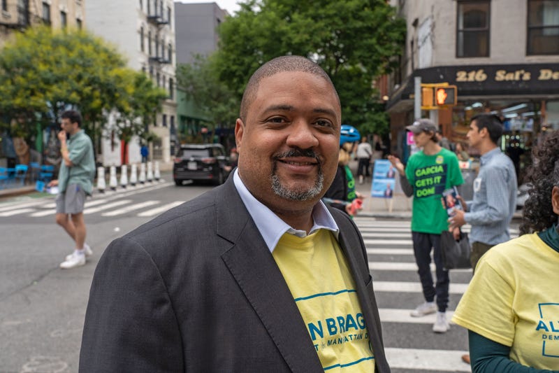 Alvin Bragg campaigns outside a polling location at Campos Plaza Community Center in New York City