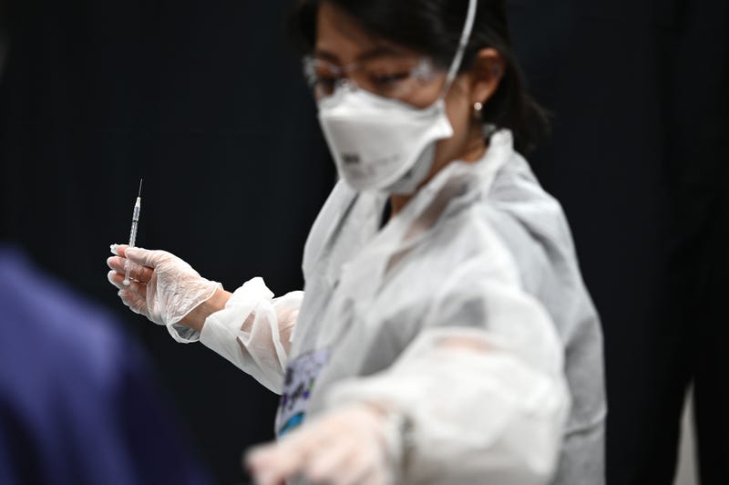 File photo: A registered nurse holds a syringe as she prepares to inoculate a person with a dose of the Pfizer BioNTech COVID-19 vaccine at city-run vaccination site in Queens