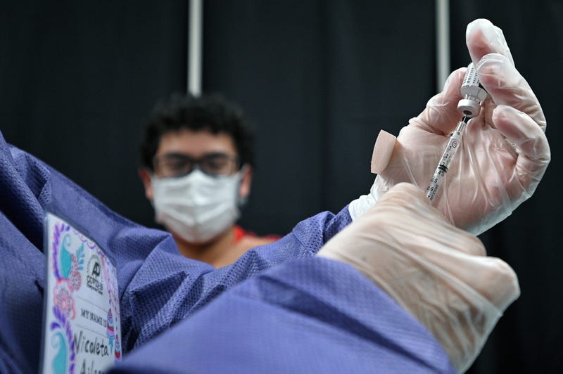 A registered nurse prepares a syringe with a dose of Pfizer COVID-19 vaccine at a vaccination site in Queens on July 30, 2021