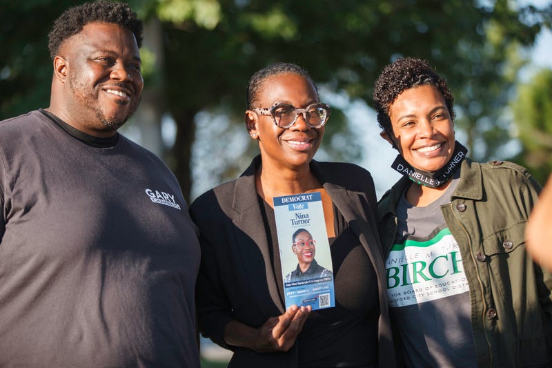 U.S. Senate candidate Gary Chambers (left) posing with Nina Turner and a woman wearing a Danielle M. Turner-Birch shirt. 