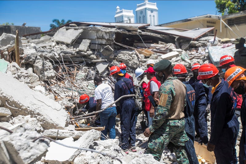 Search and rescue workers at the scene of a collapsed building in Les Cayes, Haiti, on Saturday