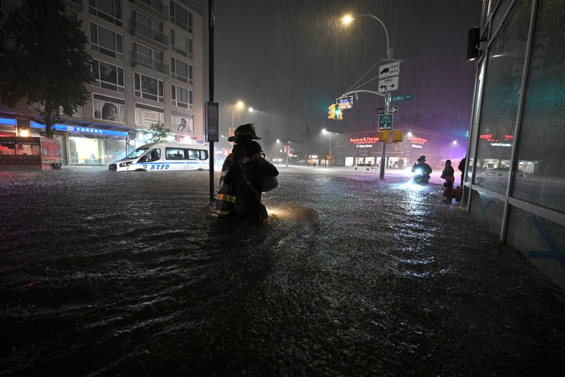 Members of the FDNY wade through waist high water caused by flash flooding brought by the remnants of hurricane Ida, in the New York City borough of Queens, NY, September 1, 2021
