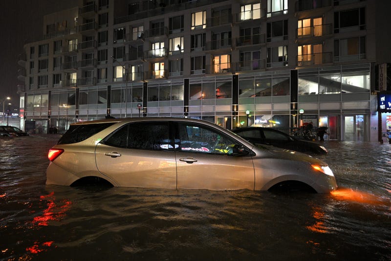 A car sits stranded in a flooded street near Queens Boulevard, caused by flash flooding brought by the remnants of hurricane Ida, in the New York City borough of Queens