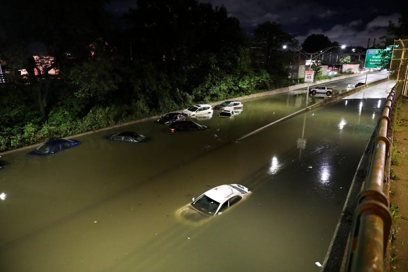 Vehicles are submerged on a waterlogged road in New York, Sept. 2, 2021