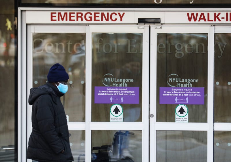 A pedestrian walks past the entrance of an emergency room of a hospital in New York City on Dec. 13, 2021