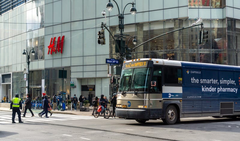 A bus turns off of West 34th Street in busy Herald Square