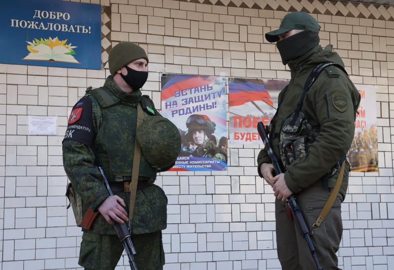 Men are seen outside a mobilization station of the military commissariat for Donetsk's Kalininsky, Kiyevsky and Voroshilovsky districts in the so-called Donetsk People’s Republic on Feb. 23, 2022