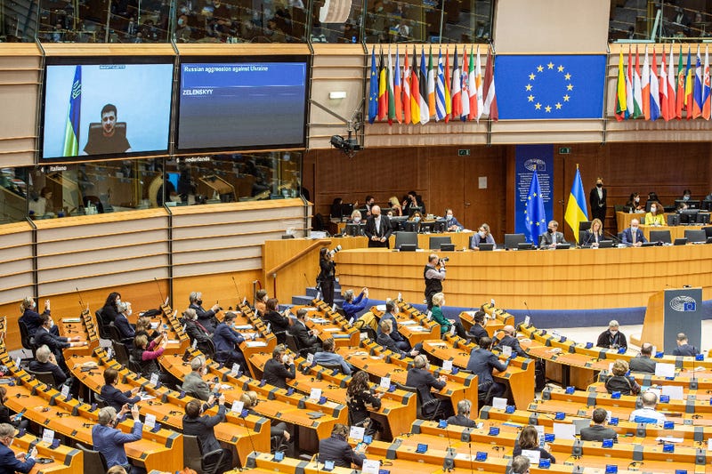 Volodymyr Zelensky, president of Ukraine, is seen on a TV screen during a plenary session of the European parliament, in Brussels on March 1, 2022.
