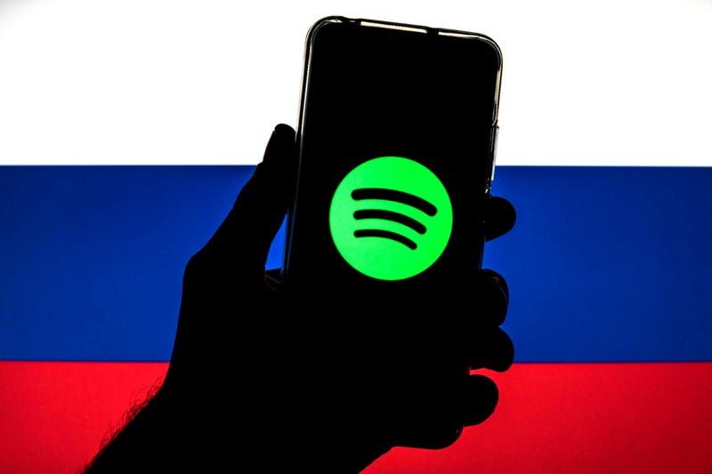 In this photo illustration a Spotify logo seen displayed on a smartphone with a flag of Russia in the background on March 11.