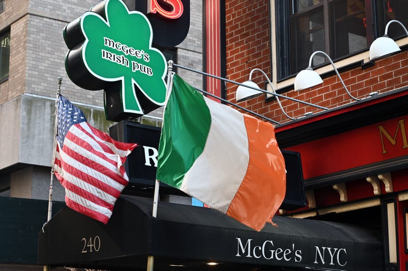 The American and Irish flag flutter in a breeze as McGee’s Irish Pub prepares to welcome back customers to celebrate St. Patrick’s Day, New York, NY, March 16, 2022