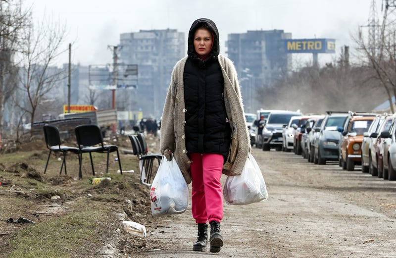 A woman follows a humanitarian corridor established for civilians in Mariupol on March 17, 2022