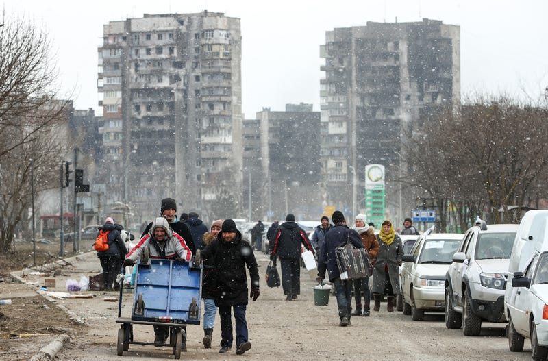 Civilians follow a humanitarian corridor from Mariupol on March 17, 2022