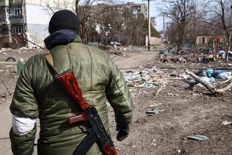 A serviceman patrols one of the streets in Mariupol on Sunday, March 20.