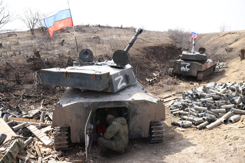 A serviceman of the Russian separatist force, LPR People's Militia, is seen by a 2S1 Gvozdika self-propelled howitzer that fires leaflet shells in the Lugansk Region of Ukraine on March 29, 2022. The leaflets call on servicemen of the Armed Forces of Ukraine to lay down their arms