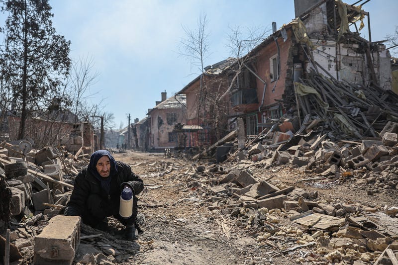 DONETSK REGION, UKRAINE - APRIL 7, 2022: A local man squats on one of the streets in Livoberezhnyi District, Mariupol.