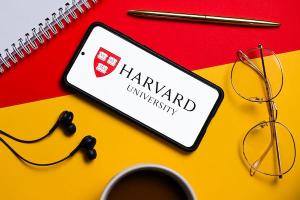 In this photo illustration a Harvard University logo seen displayed on a smartphone