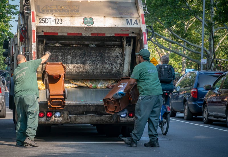 New York Dept. of Sanitation workers empty compost bins in Chelsea
