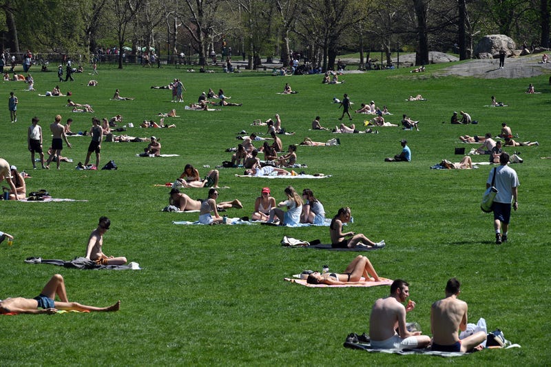 People sunbathe in Central Park’s Sheep Meadow as New York City experiences a burst of warm weather on April 13, 2023