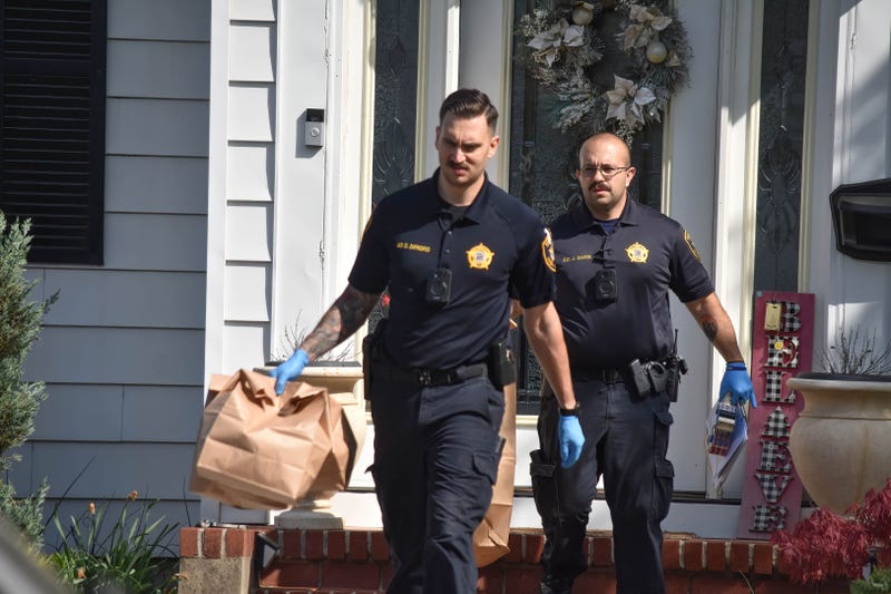 Investigators gather and collect evidence at the home in Roselle