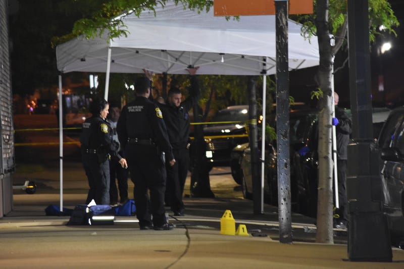 Investigators gather clues at the scene of the shooting in Newark on May 3, 2023