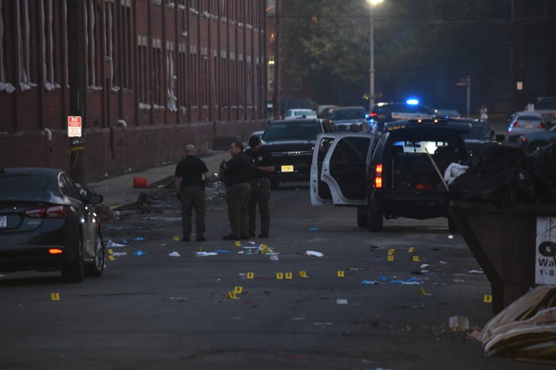 Several evidence markers located at the crime scene. Several police officers converged on the scene including crime scene investigators. Mass shooting at the intersection of Jersey Street and Oliver Street in Paterson, New Jersey, United States on July 5, 2023.