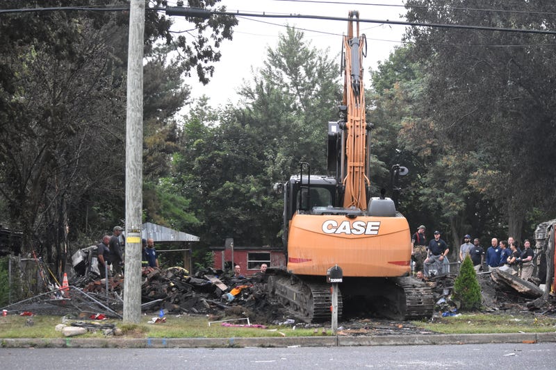 Investigators search in the rubble and debris for the bodies of those who were killed in the house explosion on the 300 block of Northwest Boulevard in Buena, New Jersey.