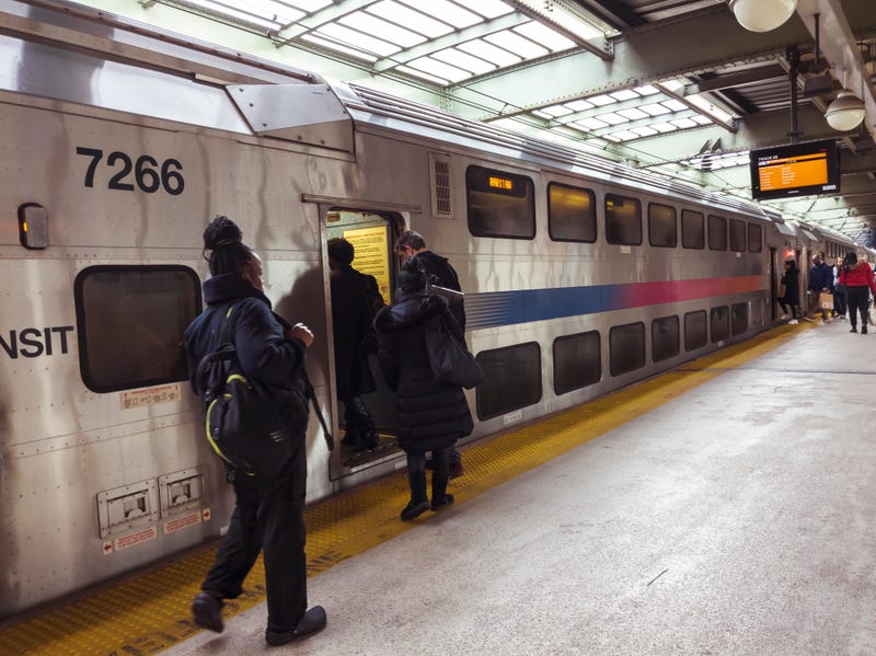 Passengers board a New Jersey Transit train on the Raritan line at Newark Penn Station