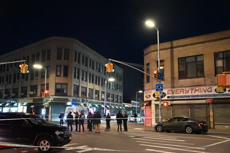 First responders are seen at Beach 20th Street and Mott Avenue in Far Rockaway after the shooting Monday evening