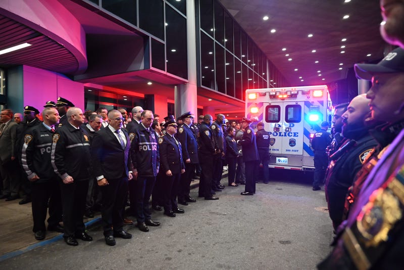 The body of NYPD Officer Jonathan Diller is placed into an ambulance during a dignified transfer at Jamaica Hospital in Queens on March 25, 2024